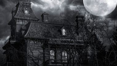spooky mansion at night with big full moon